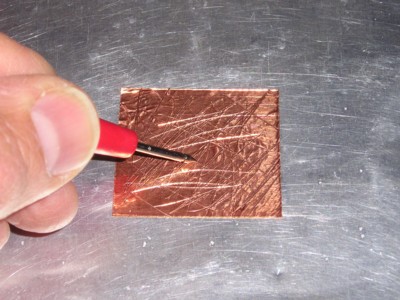scouring the foil to obtain a low resistance to the metal chassis