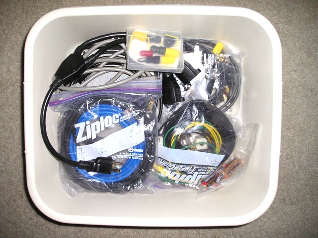 Plastic bin with bags of cables and connectors