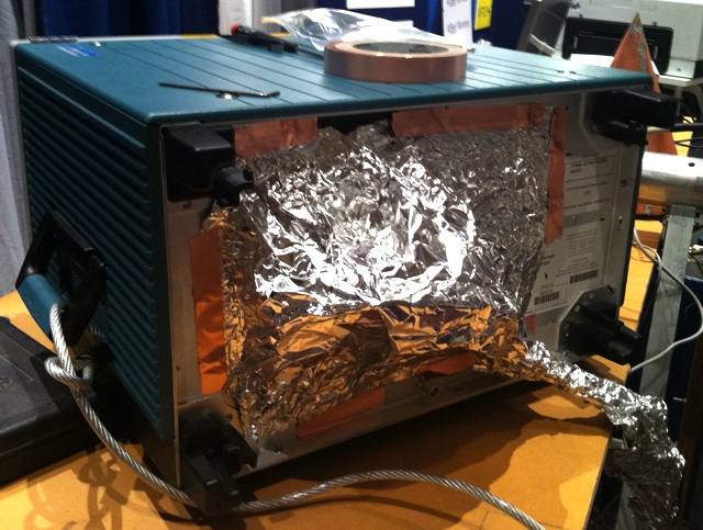 Makeshift shield applied to an oscilloscope to prevent interference